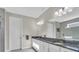 Bathroom featuring a granite countertop, dual sinks, modern lighting, and a spacious mirror at 11903 Alessandro Ln, Venice, FL 34293