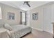 Cozy bedroom with stylish decor, neutral tones, a ceiling fan, and natural light from window at 11903 Alessandro Ln, Venice, FL 34293