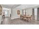 Dining room with wood-look tile flooring, chandelier lighting, and decorative curtains at 11903 Alessandro Ln, Venice, FL 34293