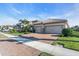 Charming home with a two-car garage, brick driveway, manicured lawn, and lush landscaping at 11903 Alessandro Ln, Venice, FL 34293