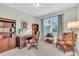 Comfortable home office with a traditional wooden desk, bookcase, and natural light at 11903 Alessandro Ln, Venice, FL 34293