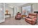 Living room featuring two comfortable leather recliners with wood floors and natural lighting at 11903 Alessandro Ln, Venice, FL 34293