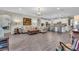 Spacious living room featuring wood floors and open concept design with kitchen and bar seating at 11903 Alessandro Ln, Venice, FL 34293