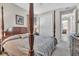 Main bedroom with a four-poster bed, closet, and dresser at 11903 Alessandro Ln, Venice, FL 34293