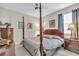 Traditional main bedroom with a dark wood four-poster bed and side tables at 11903 Alessandro Ln, Venice, FL 34293