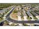 Aerial view of a community showcasing home sites, landscaping, and lake view at 11915 Tempest Harbor Loop, Venice, FL 34292