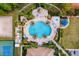 Aerial view of community pool area with beautiful lounge areas, tables, and chairs at 11915 Tempest Harbor Loop, Venice, FL 34292