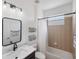 Bathroom featuring decorative black framed mirror and a shower/tub combo with updated fixtures at 11915 Tempest Harbor Loop, Venice, FL 34292