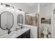 Modern bathroom featuring a double vanity, framed mirrors, and glass enclosed walk-in shower at 11915 Tempest Harbor Loop, Venice, FL 34292