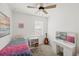 Stylish bedroom with colorful bedding, guitar, and dressing table at 11915 Tempest Harbor Loop, Venice, FL 34292