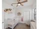 Bright Bedroom features white crib, rocking chair, and stylish decor at 11915 Tempest Harbor Loop, Venice, FL 34292