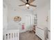 Bright Bedroom with white crib, dresser and ceiling fan at 11915 Tempest Harbor Loop, Venice, FL 34292