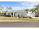 Well-kept home with a two-car garage, attractive landscaping, and palm trees at 11915 Tempest Harbor Loop, Venice, FL 34292