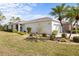 Well-kept home with a two-car garage, attractive landscaping, and palm trees at 11915 Tempest Harbor Loop, Venice, FL 34292