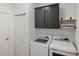 Laundry room with cabinetry, folding shelf, and modern washer and dryer at 11915 Tempest Harbor Loop, Venice, FL 34292