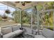 Screened-in porch featuring neutral outdoor seating and a view of the landscaped yard at 11915 Tempest Harbor Loop, Venice, FL 34292