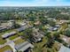 Aerial view of a residential area with lush trees and well-maintained homes, showcasing the community's appeal at 1212 Mango Ave, Venice, FL 34285