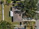 Aerial view of the home showing the layout, roof and surrounding fenced yard with mature trees at 1212 Mango Ave, Venice, FL 34285