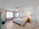 Sun-filled bedroom with a large window, neutral color palette, and tile floors for easy maintenance at 1212 Mango Ave, Venice, FL 34285