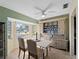 Charming dining room with tile floors, bay window and hutch with dinnerware, bathed in natural light at 1212 Mango Ave, Venice, FL 34285