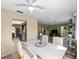 Bright dining area featuring a white ceiling fan and seamless connection to the living room and kitchen at 1212 Mango Ave, Venice, FL 34285