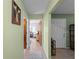 Hallway with tiled floors, light green walls, and white doors at 1212 Mango Ave, Venice, FL 34285