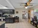 Well-lit kitchen with dark cabinetry, granite countertops, and a ceiling fan, blending functionality with style at 1212 Mango Ave, Venice, FL 34285