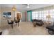 Inviting living room with dining area, tile flooring, and lots of natural light throughout the space at 1212 Mango Ave, Venice, FL 34285