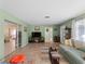 Cozy living room featuring tile floors, muted green walls, and comfortable seating, seamlessly connects to other living spaces at 1212 Mango Ave, Venice, FL 34285