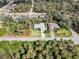 Aerial view of a home featuring a screened-in pool and lush landscaping in a quiet neighborhood at 1232 Marilyn Ln, North Port, FL 34286