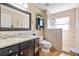 Bathroom with granite countertop vanity and a glass-enclosed walk-in shower with decorative tile work at 1232 Marilyn Ln, North Port, FL 34286