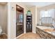 Bathroom featuring a walk-in shower, soaking tub with stone accents, and a corner shelf at 1232 Marilyn Ln, North Port, FL 34286