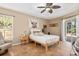 Bright bedroom with neutral tones, ceiling fan, tiled floors, and a sliding door at 1232 Marilyn Ln, North Port, FL 34286