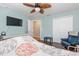 Bedroom featuring a ceiling fan, hardwood floors, chair, and natural light from the window at 1232 Marilyn Ln, North Port, FL 34286