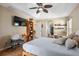 Spacious bedroom with tile flooring, large TV, and a view towards the hallway and doorway at 1232 Marilyn Ln, North Port, FL 34286