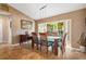 Bright dining room with stylish furniture and large windows overlooking the backyard at 1232 Marilyn Ln, North Port, FL 34286