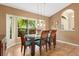 Dining area features modern table and chairs, complemented by a sun-filled window at 1232 Marilyn Ln, North Port, FL 34286