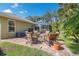 Backyard with brick patio and firepit surrounded by chairs at 1232 Marilyn Ln, North Port, FL 34286