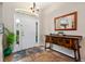 Foyer with a light-colored tile, decorative table and mirror near the front door at 1232 Marilyn Ln, North Port, FL 34286