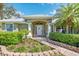 Charming front entrance with walkway, lush bushes and inviting seating at 1232 Marilyn Ln, North Port, FL 34286