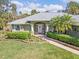 Inviting front entrance features a decorative door and two rocking chairs at 1232 Marilyn Ln, North Port, FL 34286