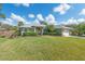 Landscaped front yard with a well-manicured lawn showcasing the home's facade at 1232 Marilyn Ln, North Port, FL 34286