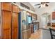 Well-equipped kitchen featuring stainless steel appliances, tile floors, and wood cabinetry at 1232 Marilyn Ln, North Port, FL 34286