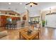 Spacious living room with tile flooring with a bar looking into the kitchen at 1232 Marilyn Ln, North Port, FL 34286