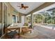 View of covered patio featuring comfortable seating with view of the pool and tropical landscape at 1232 Marilyn Ln, North Port, FL 34286