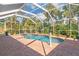 Enclosed pool featuring brick patio and lush tropical landscaping at 1232 Marilyn Ln, North Port, FL 34286