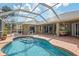 Backyard pool featuring screened in lanai and brick patio at 1232 Marilyn Ln, North Port, FL 34286