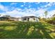 Property view showcasing home and green space at 12385 Prudential Ave, Port Charlotte, FL 33981