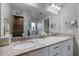 Bathroom with granite countertop, double vanity, and large mirror at 12385 Prudential Ave, Port Charlotte, FL 33981