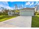 Single-story home with attached garage and landscaped front yard at 12385 Prudential Ave, Port Charlotte, FL 33981